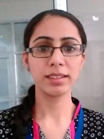 Portrait of Dr. Kapoor wearing traditional attire with academic books in background